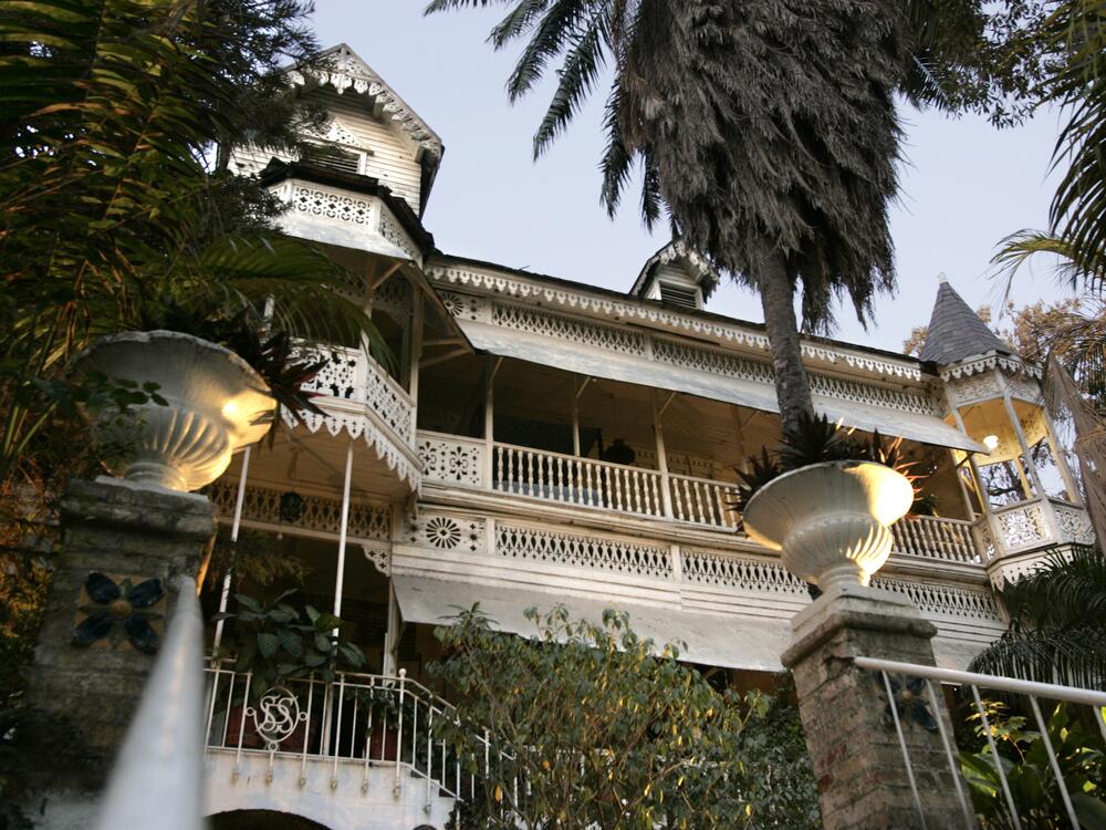 Main entry to the Hotel Oloffson, built as a private residence by Simon Sam in about 1886. American Marines leased it and turned it into a military hospital in the early 20th century. In 1936 Walter Oloffson converted it to a hotel. In the 1950s through 1970s it was a Hollywood jetset destination.