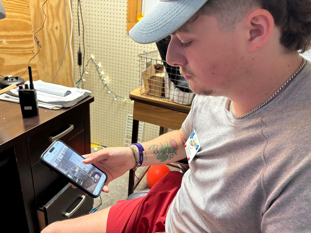 Taylor Bergmann watches a video he took while escaping the Fourth of July floods in Kerr County, Texas.