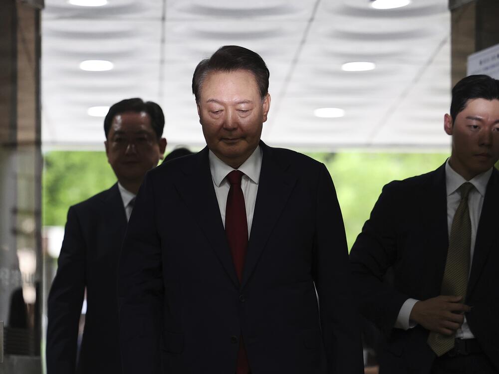 Former South Korean President Yoon Suk Yeol, centerm arrives at a court to attend a hearing to review his arrest warrant requested by special prosecutors in Seoul, South Korea Wednesday, July 9, 2025.