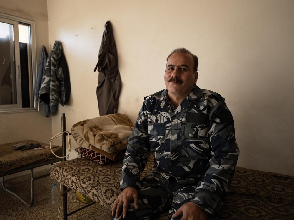Haitham Nasrallah sits on his bed at the Kafr Sousa firehouse in southwest Damascus, wearing a uniform that identifies him as a firefighter from the old regime of dictator Bashar al-Assad.