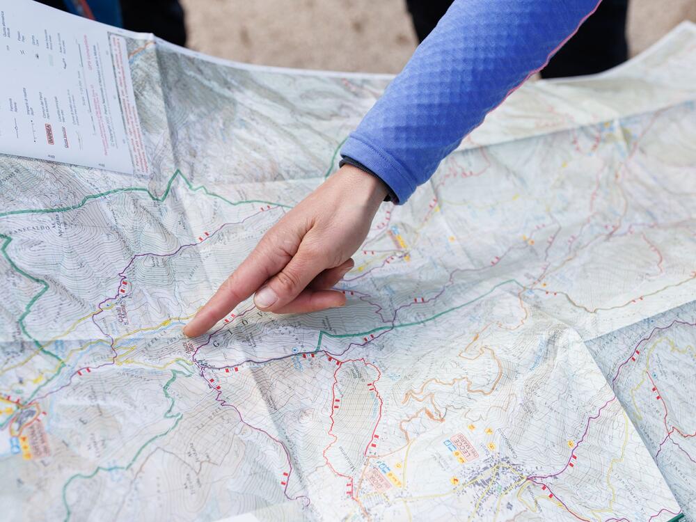 Valeria Roselli shows a hiking trail on a map.