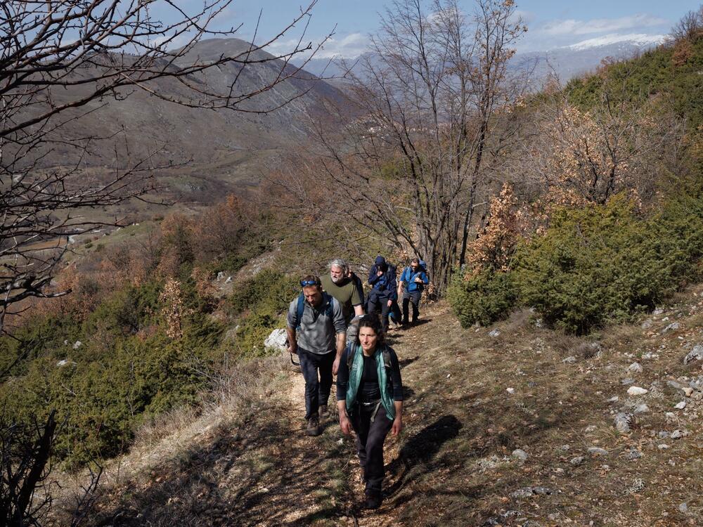 Valeria Roselli leads a tour group on the slopes of a mountain in the Giovenco Valley. After her dog was killed by wolves, she insisted that humans and their pets must adapt.