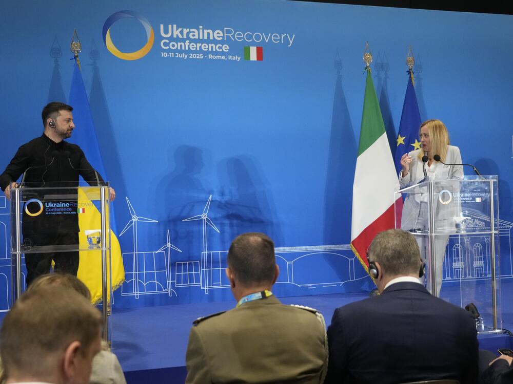 Ukraine's President Volodymyr Zelenskyy and Italian Prime Minister Giorgia Meloni speak with media reporters during the Ukraine Recovery Conference at La Nuvola convention center in Rome on Thursday.