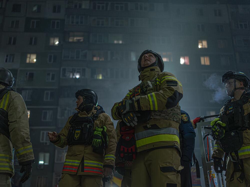 Emergency workers outside an apartment complex in the city of Sumy that was hit in a Russian drone strike early this year.