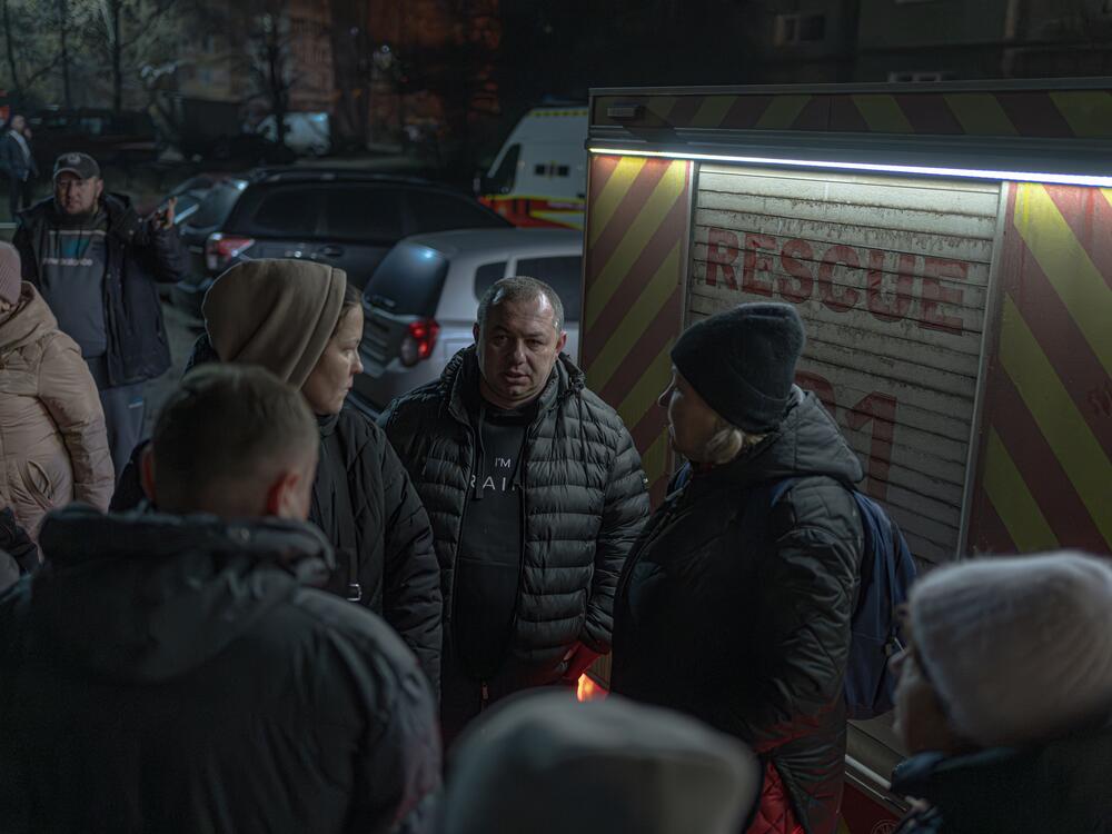 The acting mayor of Sumy, Artem Kobzar, talks to residents of an apartment complex hit by a Russian drone strike early this year.
