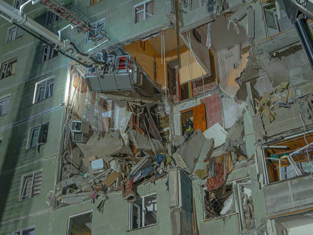 Emergency workers try to access a crushed apartment in the city of Sumy hit by an Iranian-designed attack drone launched by Russia. The attack  early this year killed 11 people and injured 14.