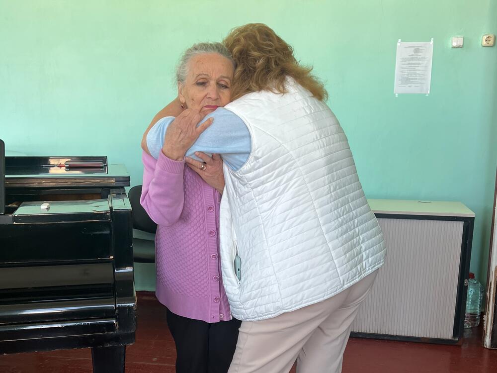 Classical voice teacher Natalia Tsylbulko embraces Nadia Hryn, who runs Sumy's music conservatory. Tsybulko's daughter Olena Kohut, killed in a Russian missile attack in April, used to teach at the school along with her mother. 