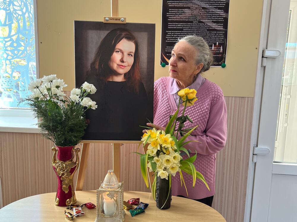 Classically trained singer and voice teacher Natalia Tsybulko gazes at a portrait of her daughter, Olena Kohut, the regional philharmonic's organist soloist, who was killed in a Russian missile attack in Sumy in April.