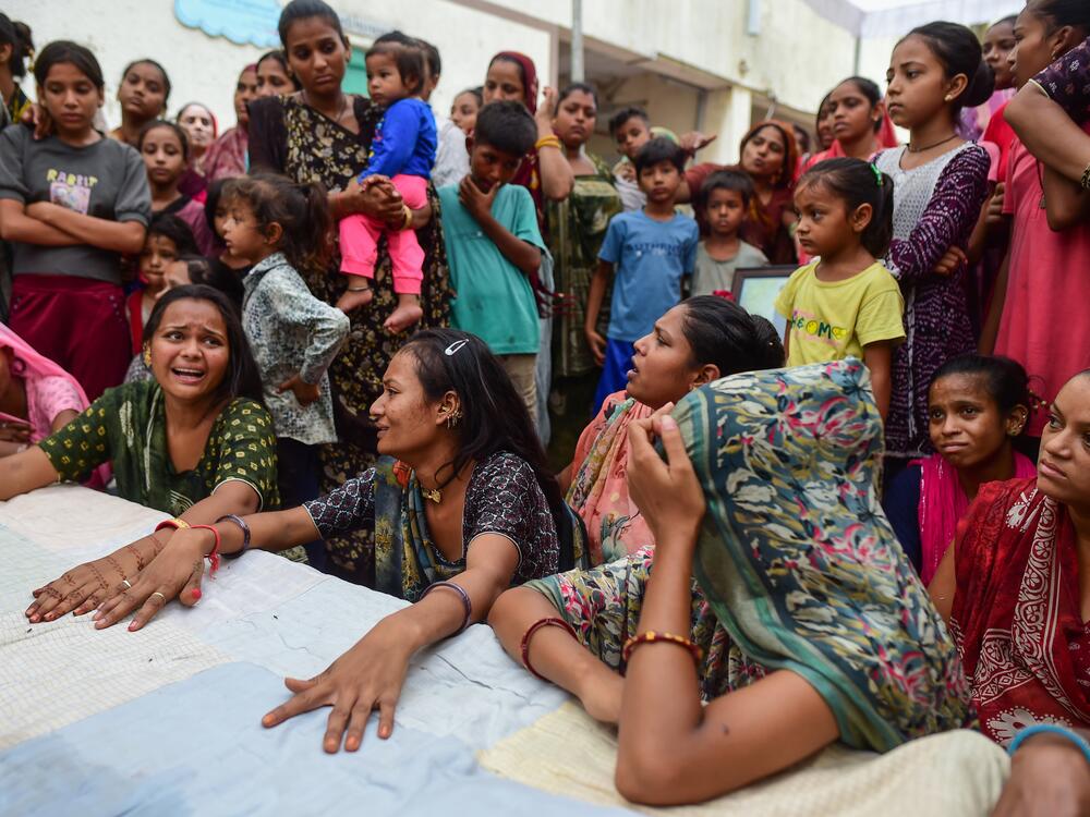 Relatives and neighbors of Akash Patni, a 14-year-old tea vendor who died in Air India Boeing 787 Crash, mourn as they wait for the body at his residence, on June 15, 2025 in Ahmedabad, India. The Boeing 787 Dreamliner crashed shortly after takeoff, killing 241 of the 242 people on board. The plane crashed on June 12, 2025, after the pilot issued a mayday call to air traffic control.