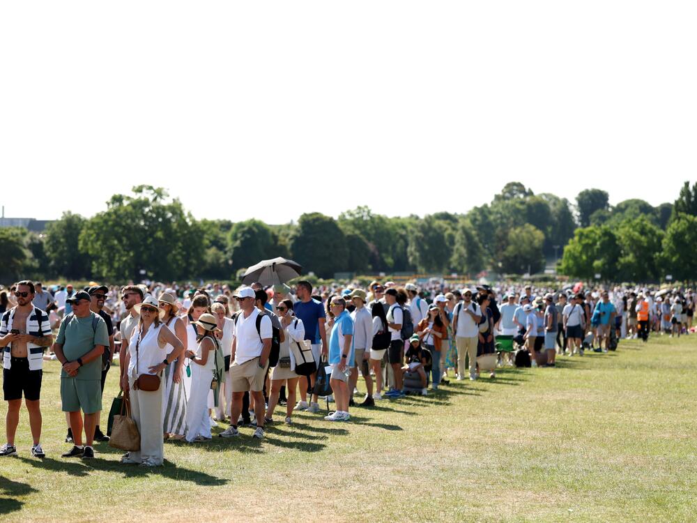 Spectators wait in the Queue on day one of Wimbledon, June 30.
