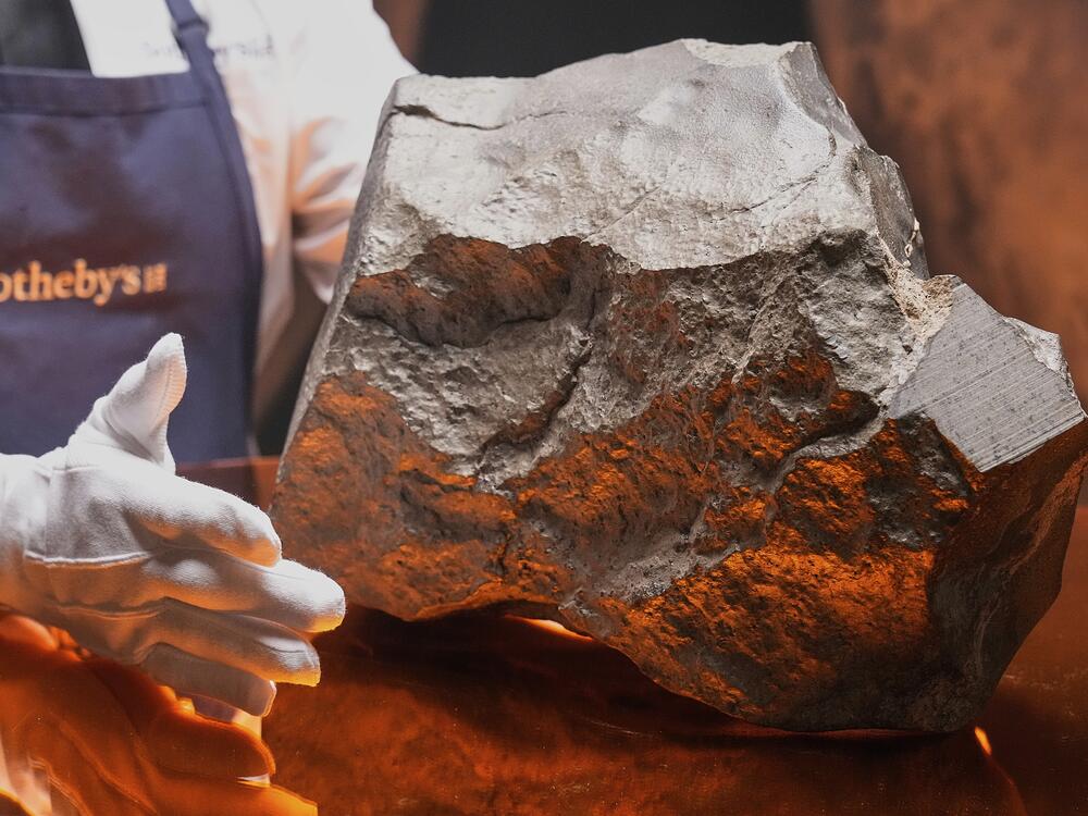 A Martian meteorite said to be the largest piece of Mars on Earth, estimated at $2 - 4 million, is displayed at Sotheby's, in New York.