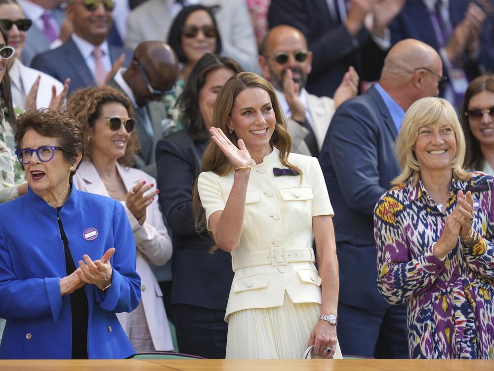 Britain's Kate, Princess of Wales, center, waves as she stands alongside tennis legend Billie Jean King in the Royal Box on Centre Court ahead of the women's singles final at the Wimbledon Tennis Championships in London, Saturday, July 12, 2025.