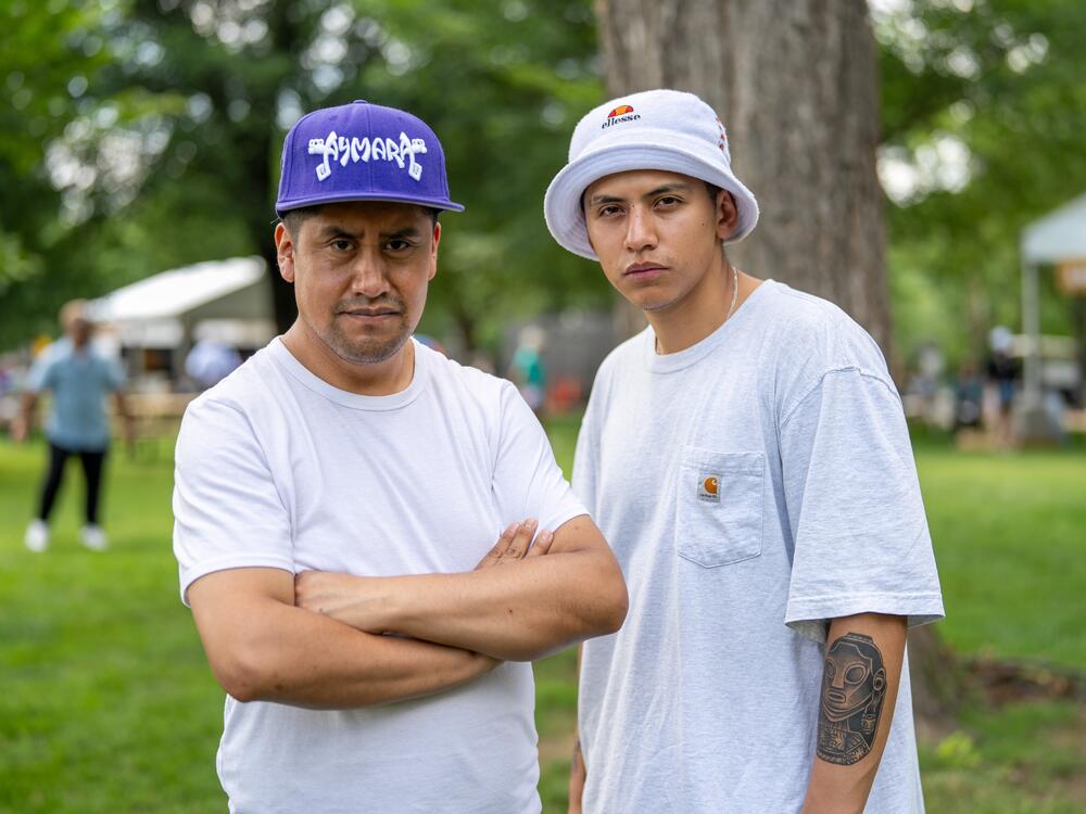 Quisbert and Orellana wear their indigenous heritage with pride. Quisbert sports a baseball hat that reads 
