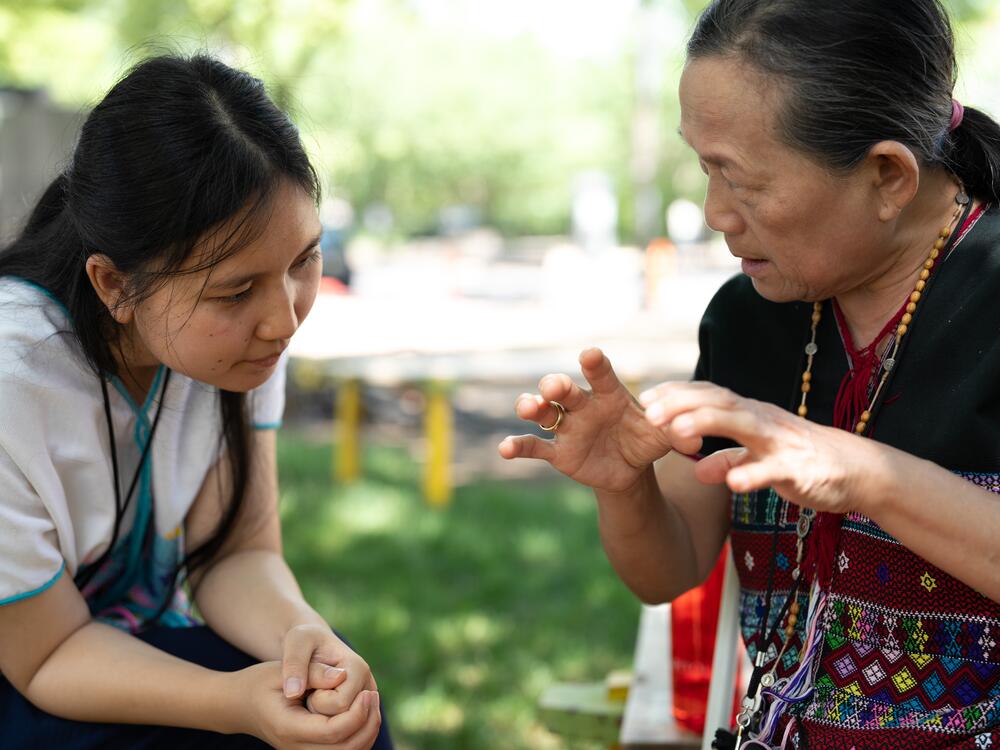 Rosie Say, right, is a master weaver who shares her knowledge with younger members of the Karen community in St. Paul, Minnesota. She is with Ku Say, who has been weaving since she was 15, learning the craft from Rosie and her mother.