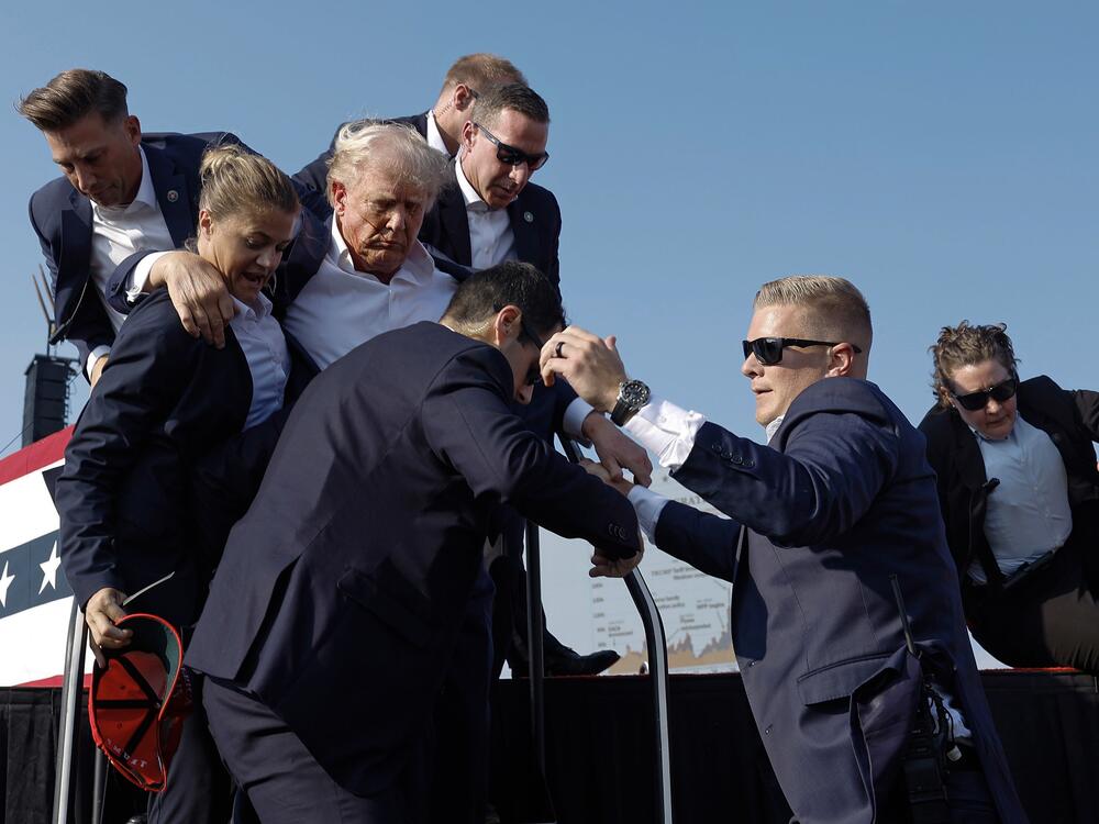 Then-candidate Donald Trump is rushed offstage by U.S. Secret Service agents after being struck by a bullet during a rally on July 13, 2024, in Butler, Pa.