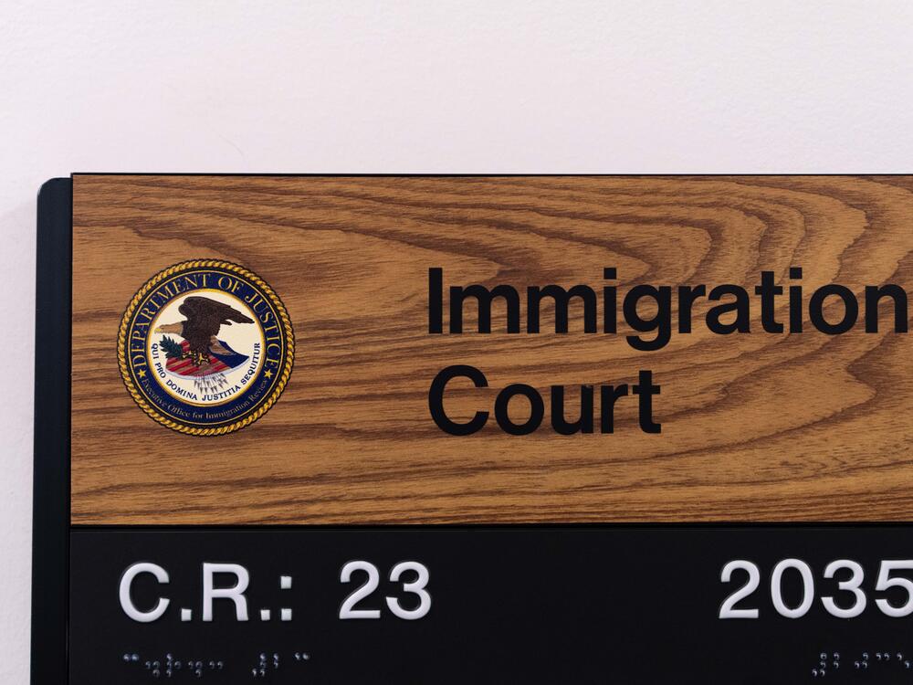 A sign shows the location of an immigration court in New York City. In July, 15 more immigration judges were fired.