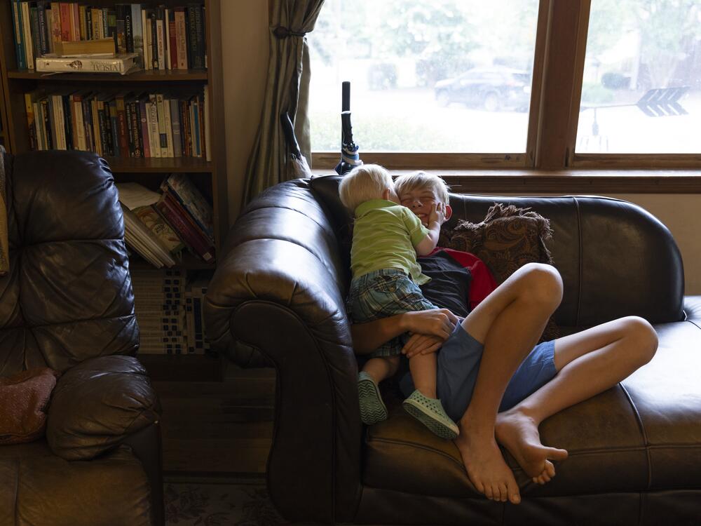Dimitry plays with his youngest brother, Sven, at their home.