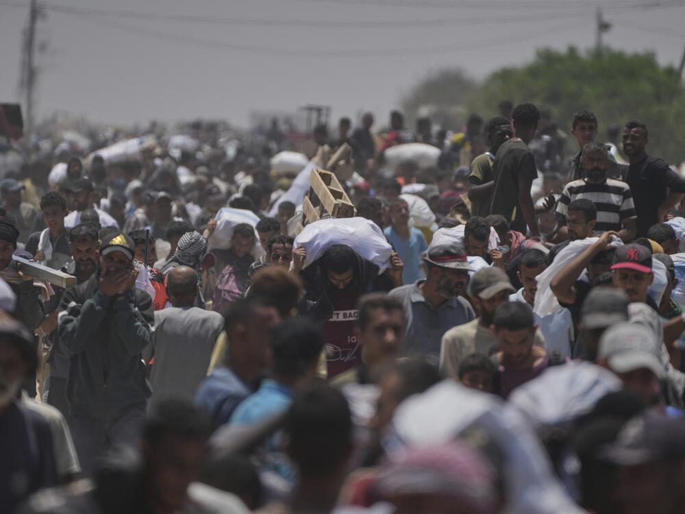 Palestinians carry bags containing food and humanitarian aid packages delivered by the Gaza Humanitarian Foundation, a U.S.-backed organization, in Rafah, southern Gaza Strip, June 9.