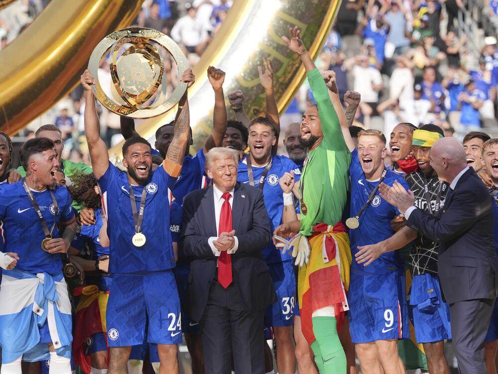 Chelsea's Reece James (24) lifts the trophy as President Donald Trump looks on following the Club World Cup final soccer match between Chelsea and PSG in East Rutherford, N.J. on Sunday.