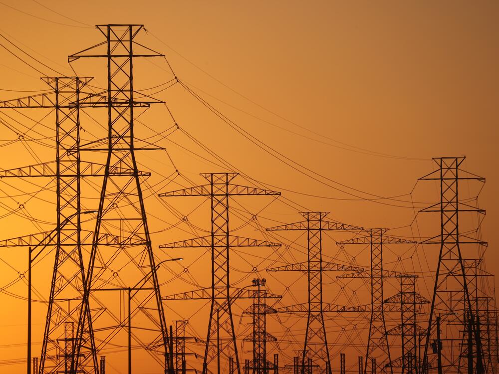 A view of high-voltage transmission towers in Houston. The law President Trump signed on July 4 ends tax incentives for wind and solar projects and is expected to drive up electricity bills across the U.S., according to a nonpartisan think tank.