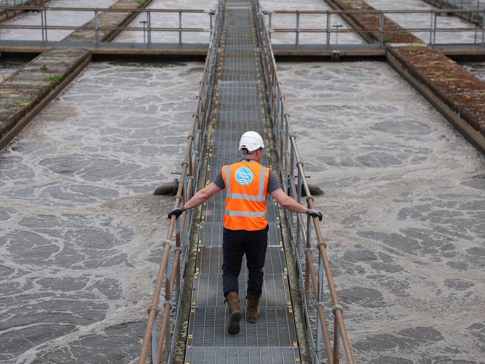 Ashley Book, head of waste operations at Mogden Catchment, walks between aeration lanes used to process sewage water from over 2 million people, at Mogden Sewage Treatment Works, operated by Thames Water, in west London, June 4.