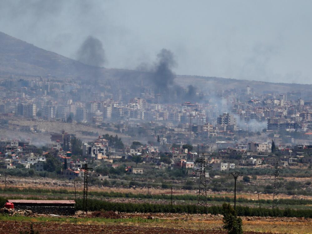 Smoke rise from clashes between Syrian government forces and Druze militias in Sweida city, southern Syria on Tuesday.