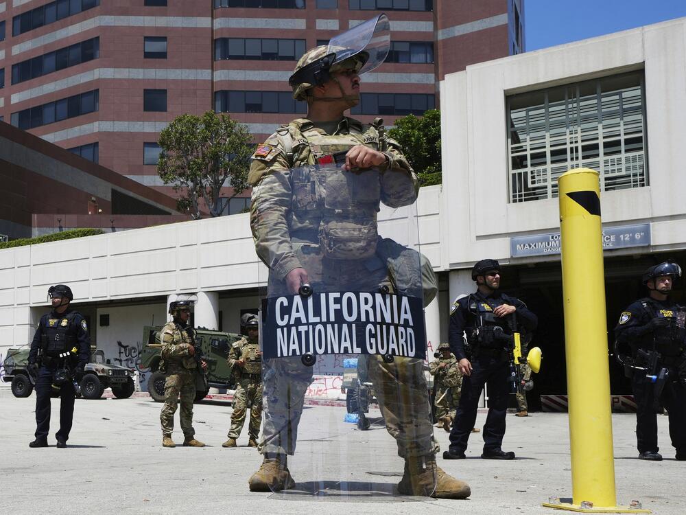 FILE - A California National Guardsmen stands to protect federal buildings, June 10, 2025, in Los Angeles.