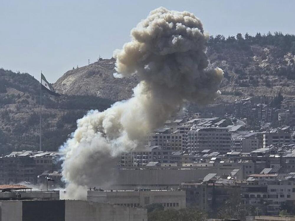In this photo released by the Syrian official news agency SANA, smoke rises from an Israeli airstrike that hit the Syrian Defense Ministry, in Damascus, Syria, Wednesday.