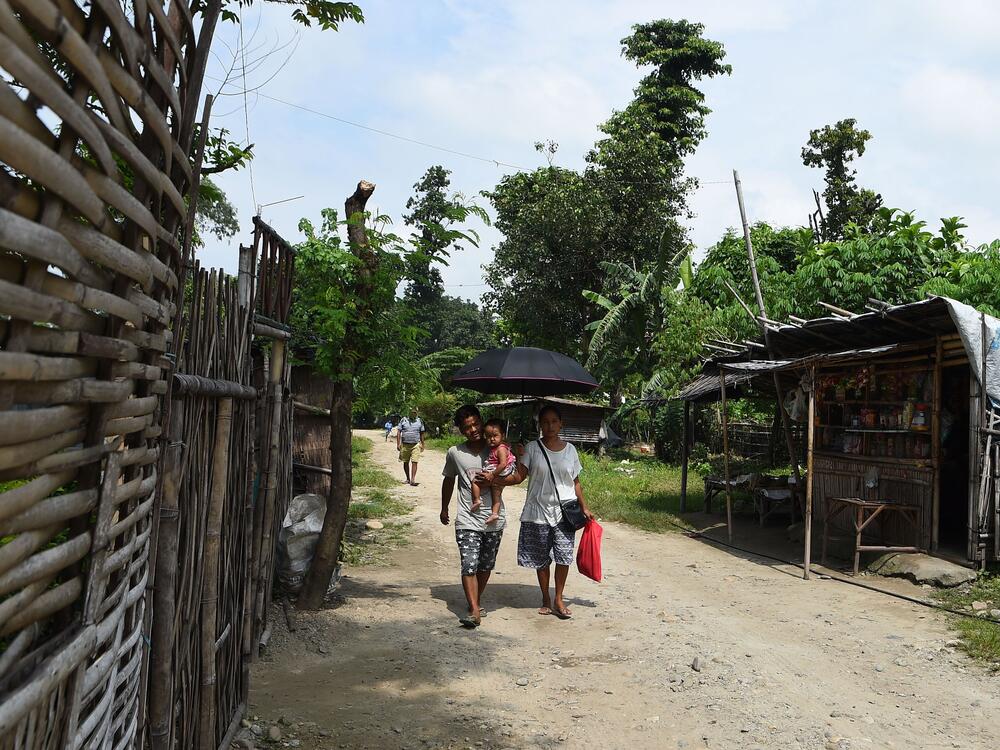 This picture taken on Aug. 10, 2018 shows members of a Nepali-speaking Bhutanese refugee family walking in a refugee camp in Damak, Nepal.