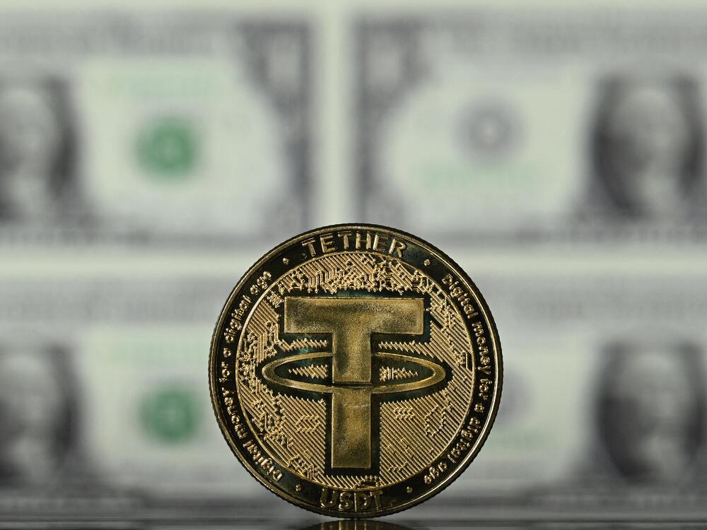 An illustration picture taken in London on May 8, 2022, shows a souvenir Tether (USDT) coin, which is one of the world's biggest stablecoins.