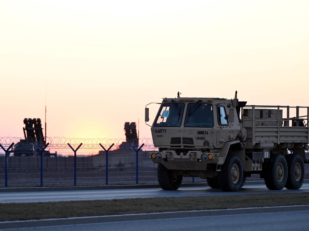 A military vehicle drives by Patriot air defense systems installed at the Rzeszow-Jasionka airport, a logistics hub for U.S. and European military aid to Ukraine, in southeastern Poland on March 6.