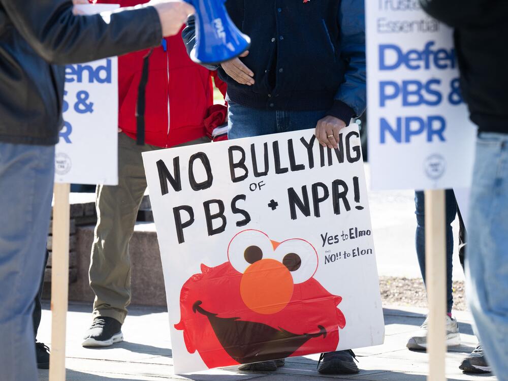 A poster at a March 26 rally to protect funding for U.S. public broadcasters, PBS and NPR outside the NPR headquarters in Washington, D.C.