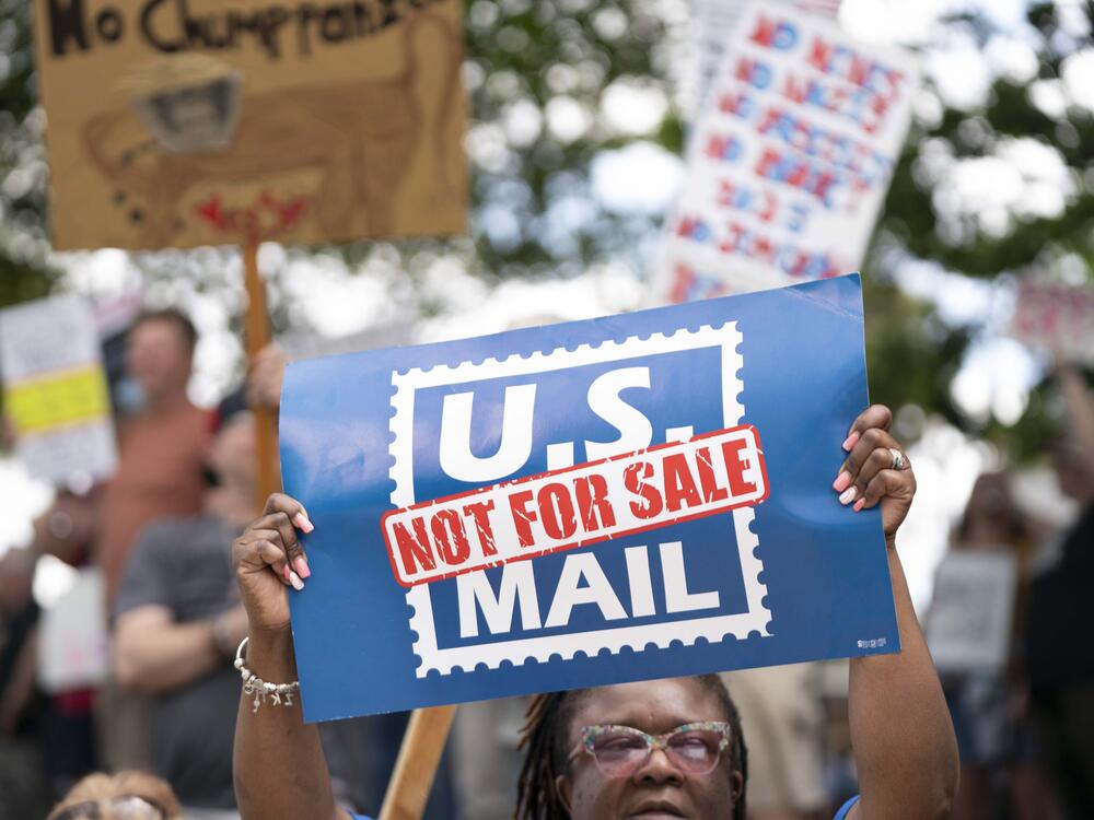 A demonstrator holds a sign that says 