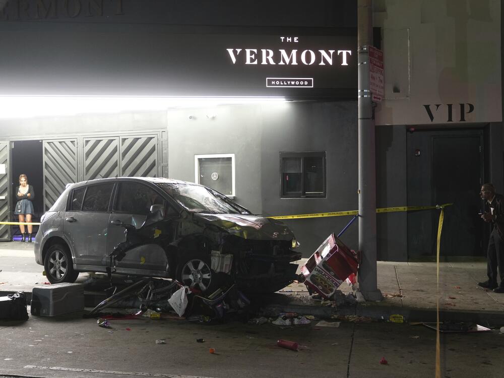 A vehicle sits on the sidewalk after ramming into a crowd of people waiting to enter a nightclub along a busy boulevard in Los Angeles early Saturday, July 19, 2025 injuring several people.