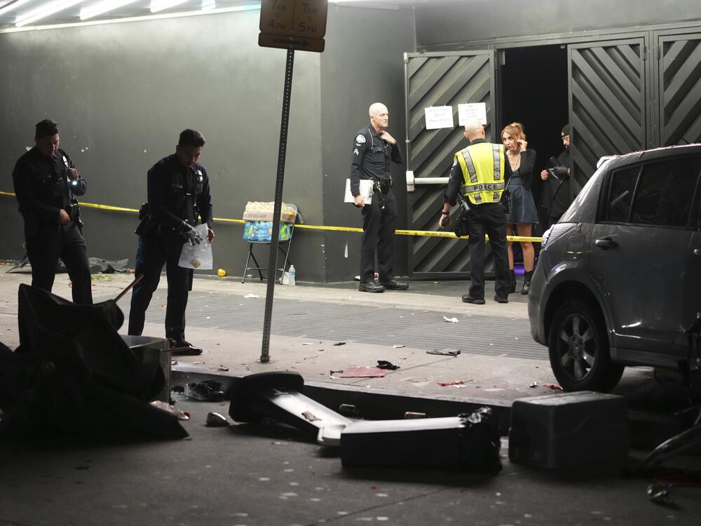 Law enforcement investigate the scene where a vehicle rammed into a crowd of people waiting to enter a nightclub along a busy boulevard in Los Angeles early Saturday, July 19, 2025 injuring several people.