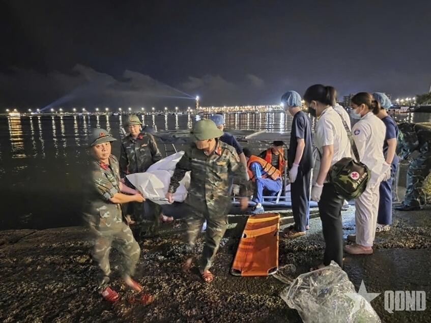 This image from a video provided by QDND shows a body being carried on stretcher after a tourist boat capsized in Ha Long Bay, Vietnam on Saturday, July 19, 2025.