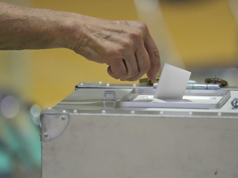 A voter casts a ballot in the upper house elections at a polling station Sunday, July 20, 2025, in Tokyo. (AP Photo/Eugene Hoshiko)