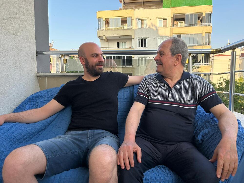 Adham Aljamous, 32, and his father Nouruldeen, 72, on their rooftop in Gaziantep, Turkey. They fled Syria over a decade ago. Now, with a chance to return, they're unsure what's left of home.