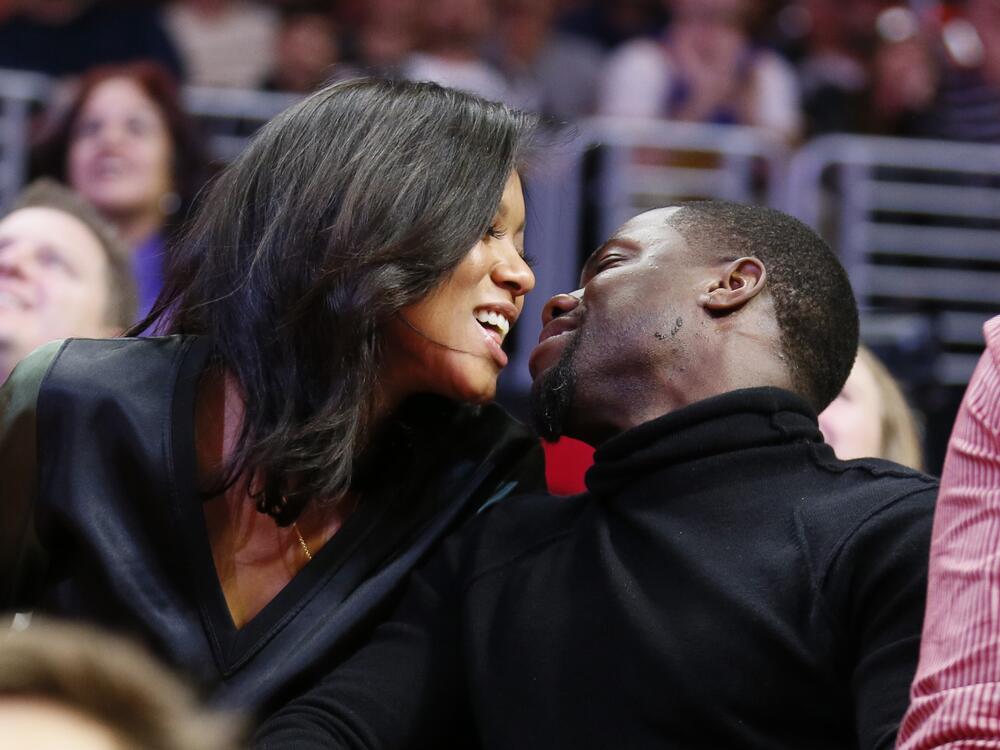 Kiss cams often capture moments of delight, such as this 2014 smooch between comedian Kevin Hart and fiancee Eniko Parrish at an NBA basketball game between the Golden State Warriors and Los Angeles Clippers in Los Angeles. But as this week's incident involving a tech CEO and his human resources head shows, kiss cam footage can cause trouble.