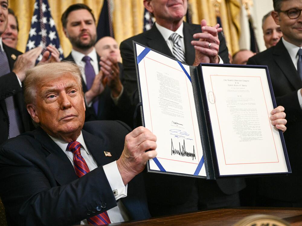President Trump displays the GENIUS Act — the first major crypto legislation passed by Congress — after signing it in the White House in Washington, D.C., on July 18, 2025.
