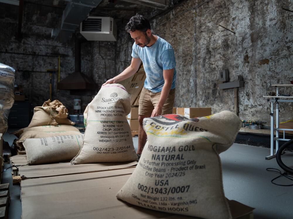 Jeff Yerxa, co-owner of Lost Sock Roasters, shows bags of coffee beans, many from Brazil, at the company's warehouse in Washington, D.C. The looming threat of a 50% tariff on all goods from Brazil — the world's largest coffee producer — has sent shock waves through the U.S. coffee industry.