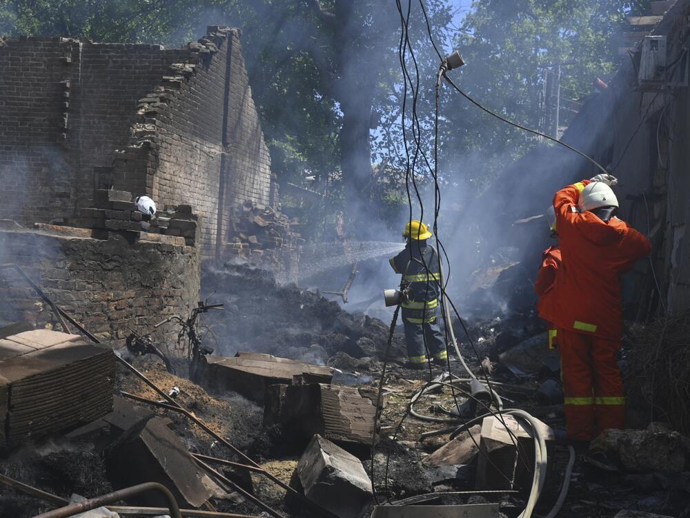 Emergency services personnel work to extinguish a fire following a Russian attack in Odesa, Ukraine, on July 11.