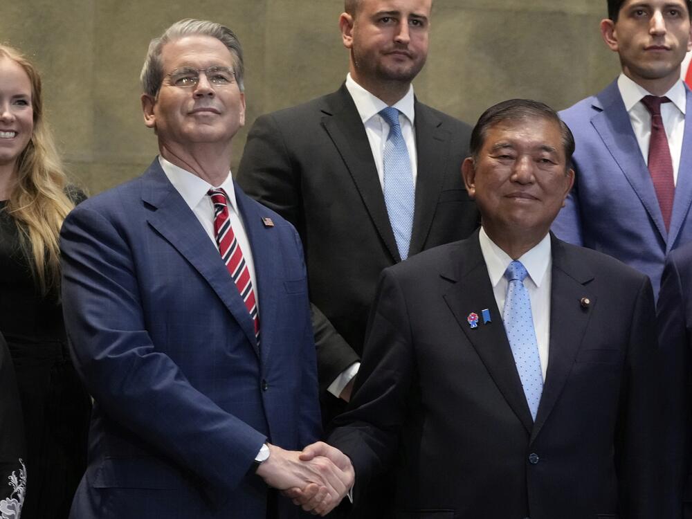 Japanese Prime Minister Shigeru Ishiba, right, shakes hands with U.S. Treasury Secretary Scott Bessent before their meeting at the prime minister's office in Tokyo on July 18, 2025.