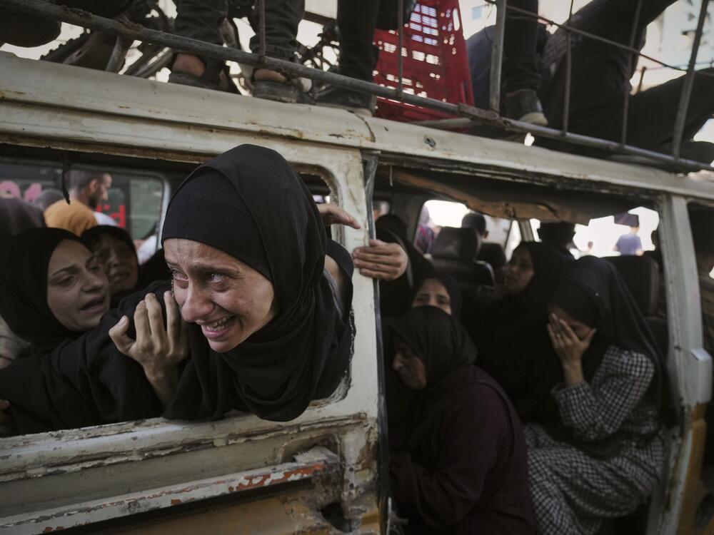 Palestinians mourn their relatives killed from an Israeli army bombardment of Gaza, at Shifa Hospital in Gaza City, Tuesday.