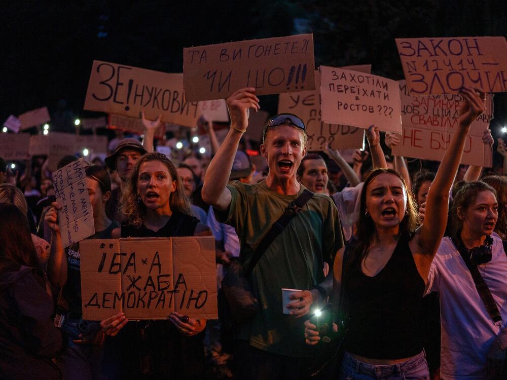 People chant while holding banners during a protest against a law targeting anti-corruption institutions in central Kyiv, Ukraine, on Tuesday.