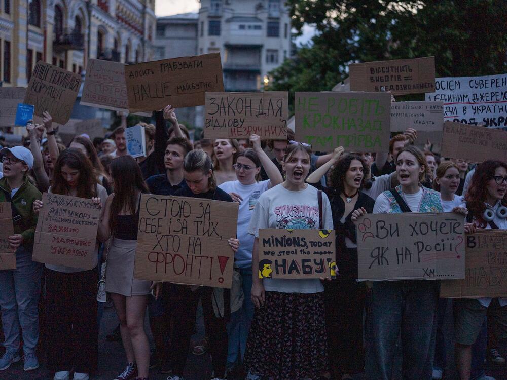 Protestant chant while holding banners that read 