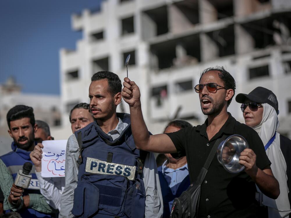 Palestinian journalists, children and families gather to demand an end to Israeli attacks and the entry of humanitarian aid, on July 19, in Gaza City. Highlighting the growing food shortage, demonstrators held banners reading 