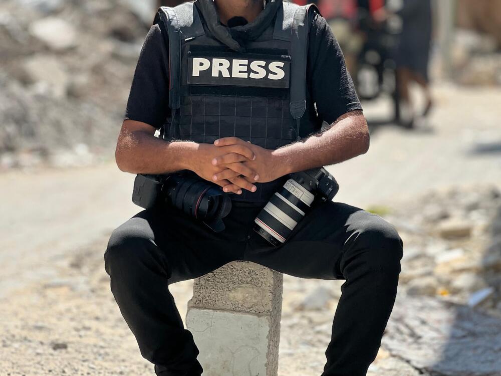 AFP journalist Bashar Taleb poses for a picture in the Gaza Strip on Tuesday. The agency's Palestinian text, photo and video journalists say that shortages of food and water are making them sick and exhausted.