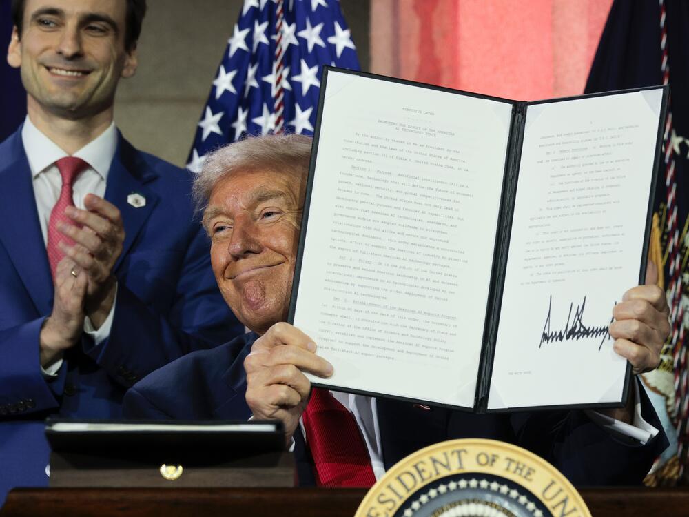 President Trump displays a signed executive order after delivering remarks on his AI plan at the Andrew W. Mellon Auditorium on July 23, 2025 in Washington, DC.