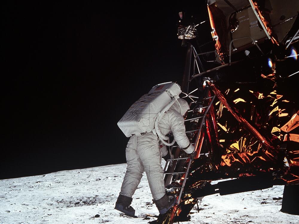 Astronaut Edwin E. Aldrin, Jr., lunar module pilot, descends the steps of the lunar module ladder on July 20, 1969, as he prepares to walk on the moon.